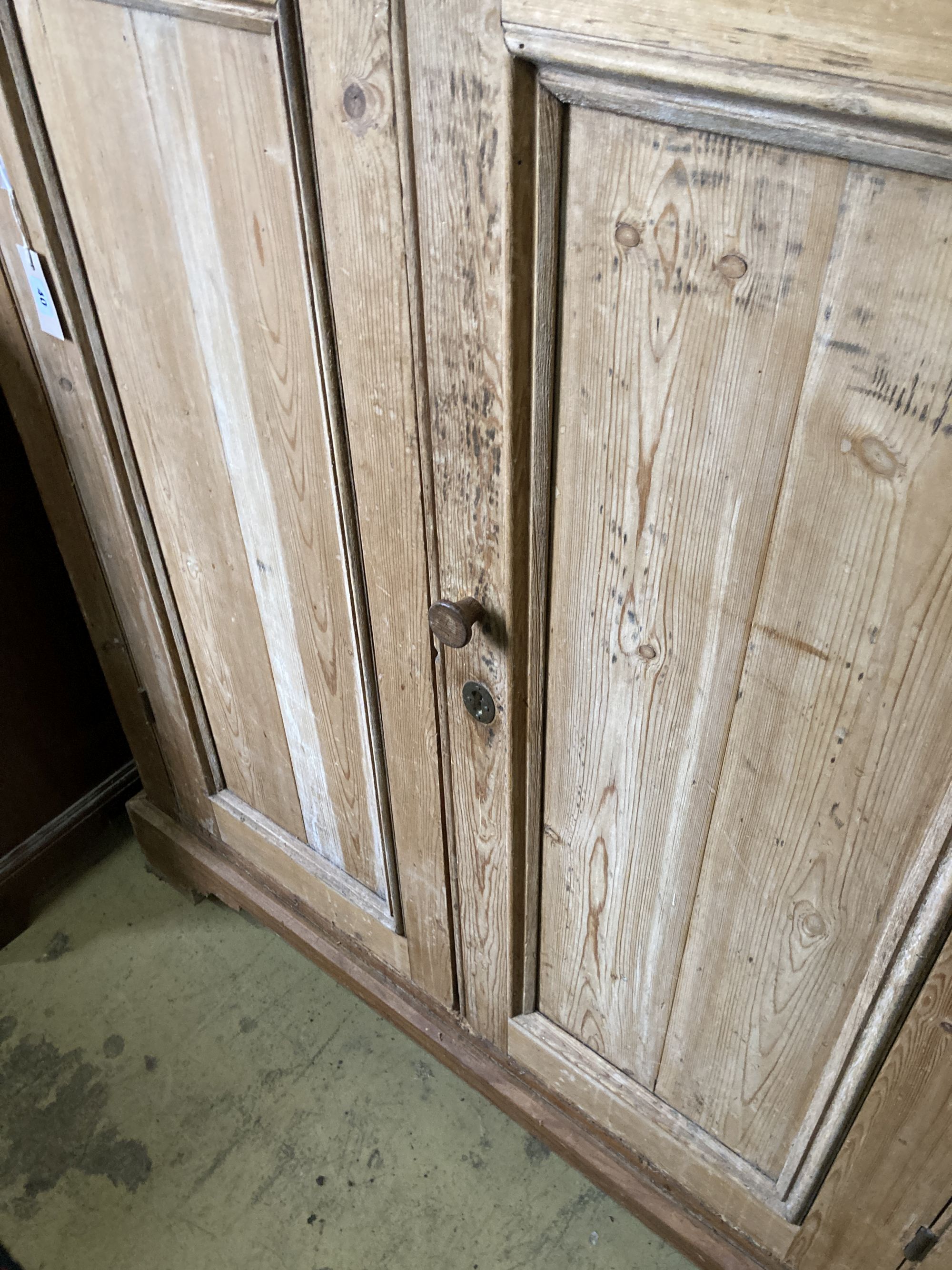 A Victorian pine two door cabinet, width 109cm, depth 37cm, height 127cm